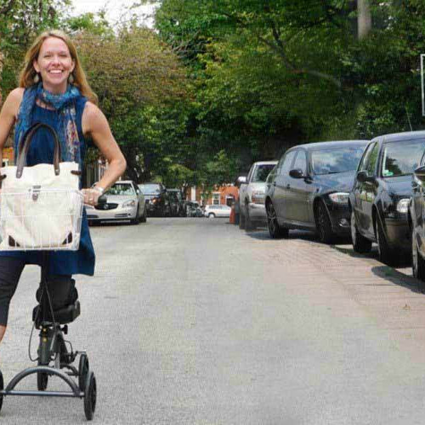 Happy woman using knee scooter