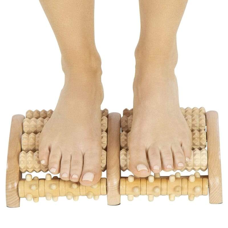 Reflexology - Foot Massage with Wooden Massage Tool. Stock Photo